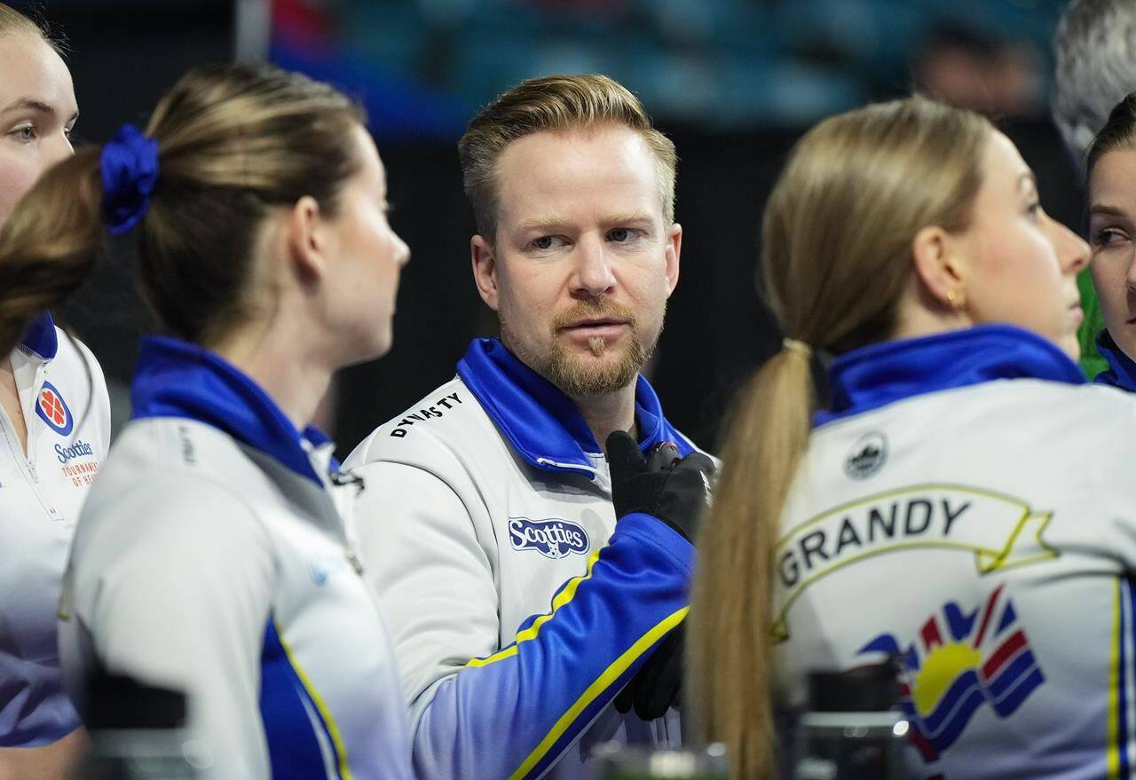 British Columbia coach Niklas Edin, back centre, talks with third Kayla MacMillan, front left, as skip Clancy Grandy, front right, looks on before playing Prince Edward Island at the Scotties Tournament of Hearts, in Kamloops, B.C., on Friday, February 17, 2023. THE CANADIAN PRESS/Darryl Dyck