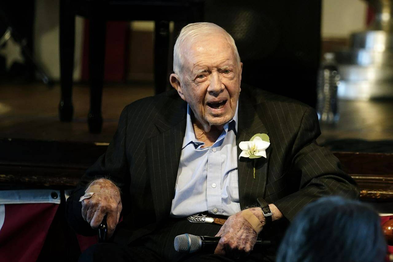Former President Jimmy Carter reacts as his wife Rosalynn Carter speaks during a reception to celebrate their 75th wedding anniversary Saturday, July 10, 2021, in Plains, Ga. The now-98-year-old Carter started hospice care at his home this weekend, prompting a rush of remembrances, including a consequential piece of international nuclear history that played out at Ontario’s Chalk River Laboratories more than 70 years ago. THE CANADIAN PRESS/AP Photo/John Bazemore, Pool
