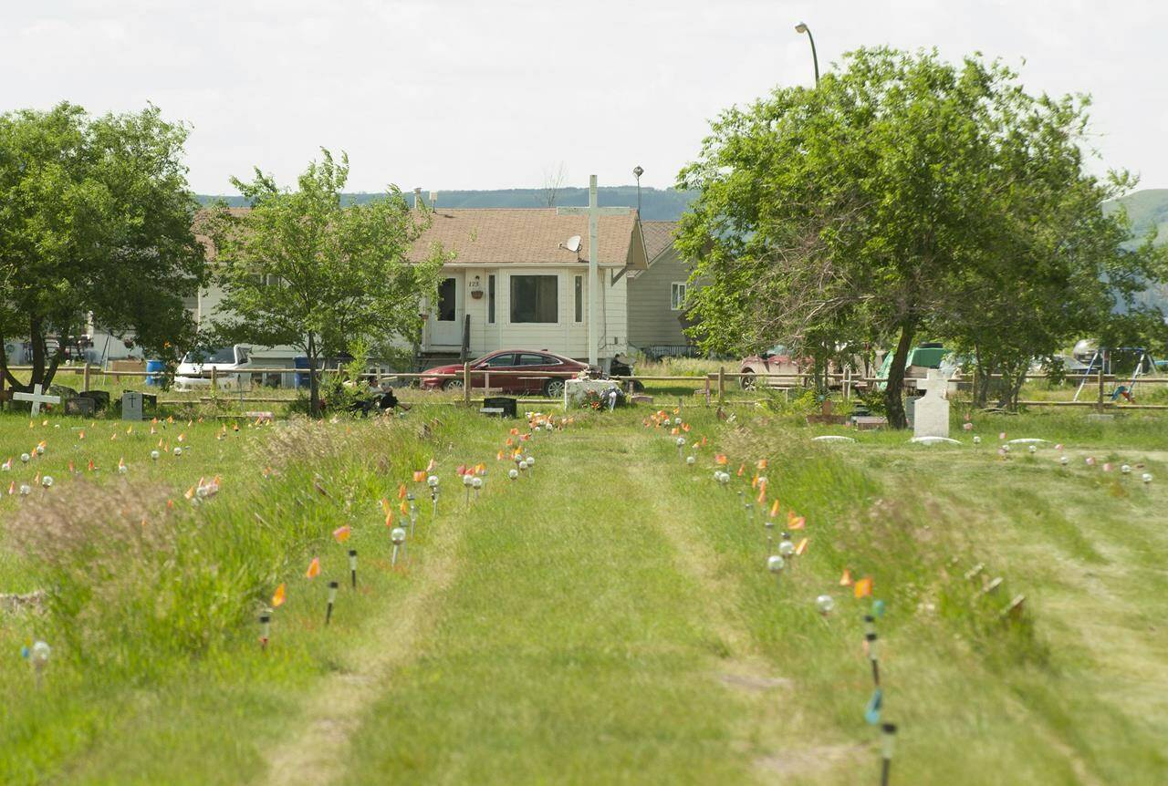 Flags mark where ground-penetrating radar recorded hits of what are believed to be 751 unmarked graves in this cemetery near the grounds of the former Marieval Indian Residential School on the Cowessess First Nation, Sask. on Saturday, June 26, 2021. The National Centre for Truth and Reconciliation says there are many problems with a $2 million contract Ottawa signed with an international group to provide it with advice on unmarked graves. THE CANADIAN PRESS/Mark Taylor