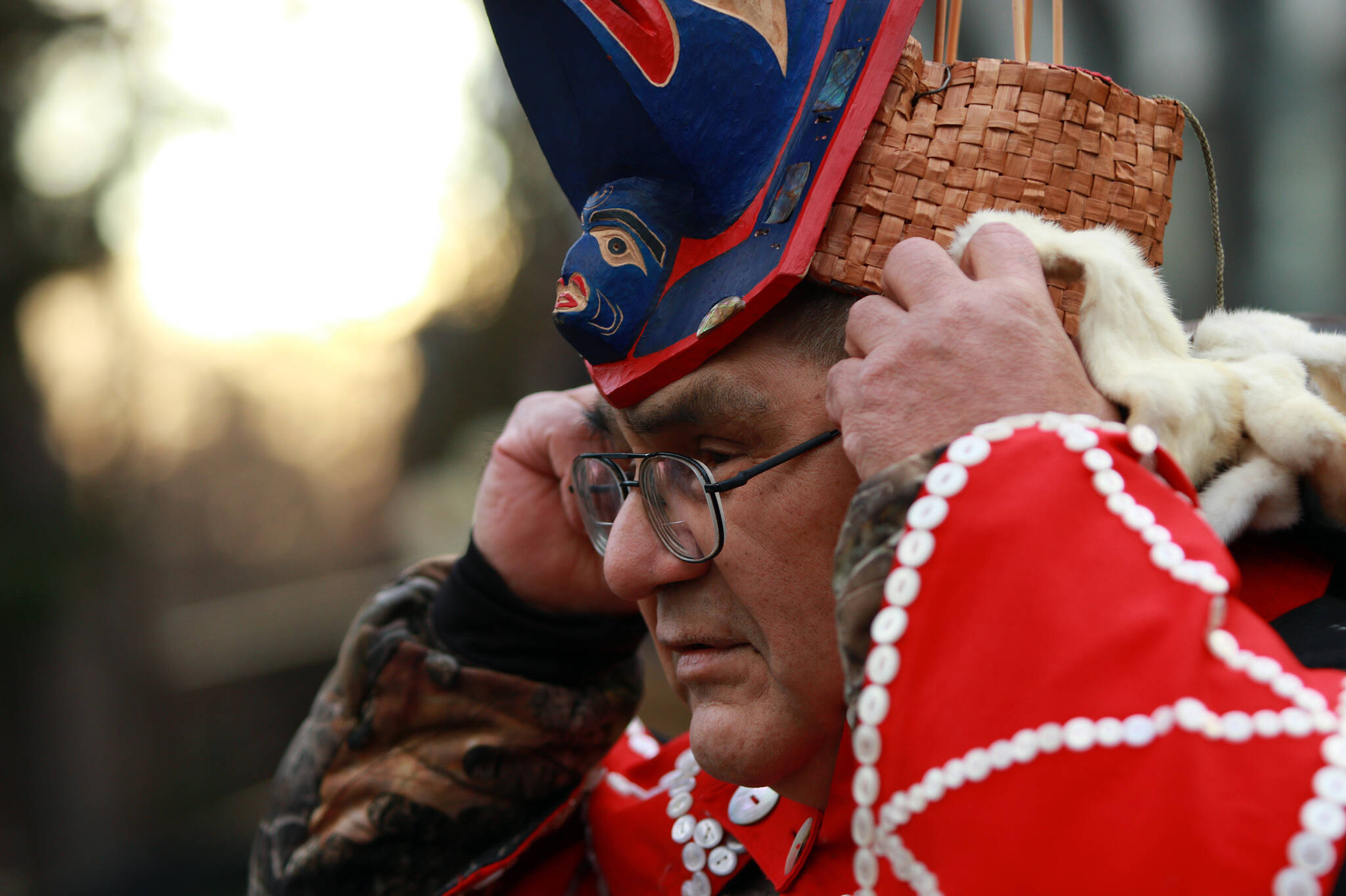 Hereditary chief Deric Snow adjusts his glasses as he joins family and friends to witness the historical repatriation of the Nuxalk Nation totem pole carved by the late Louie Snow after years of effort to release the pole back to the nation from the Royal BC Museum during a ceremony in Victoria, B.C., on Monday, February 13, 2023. THE CANADIAN PRESS/Chad Hipolito