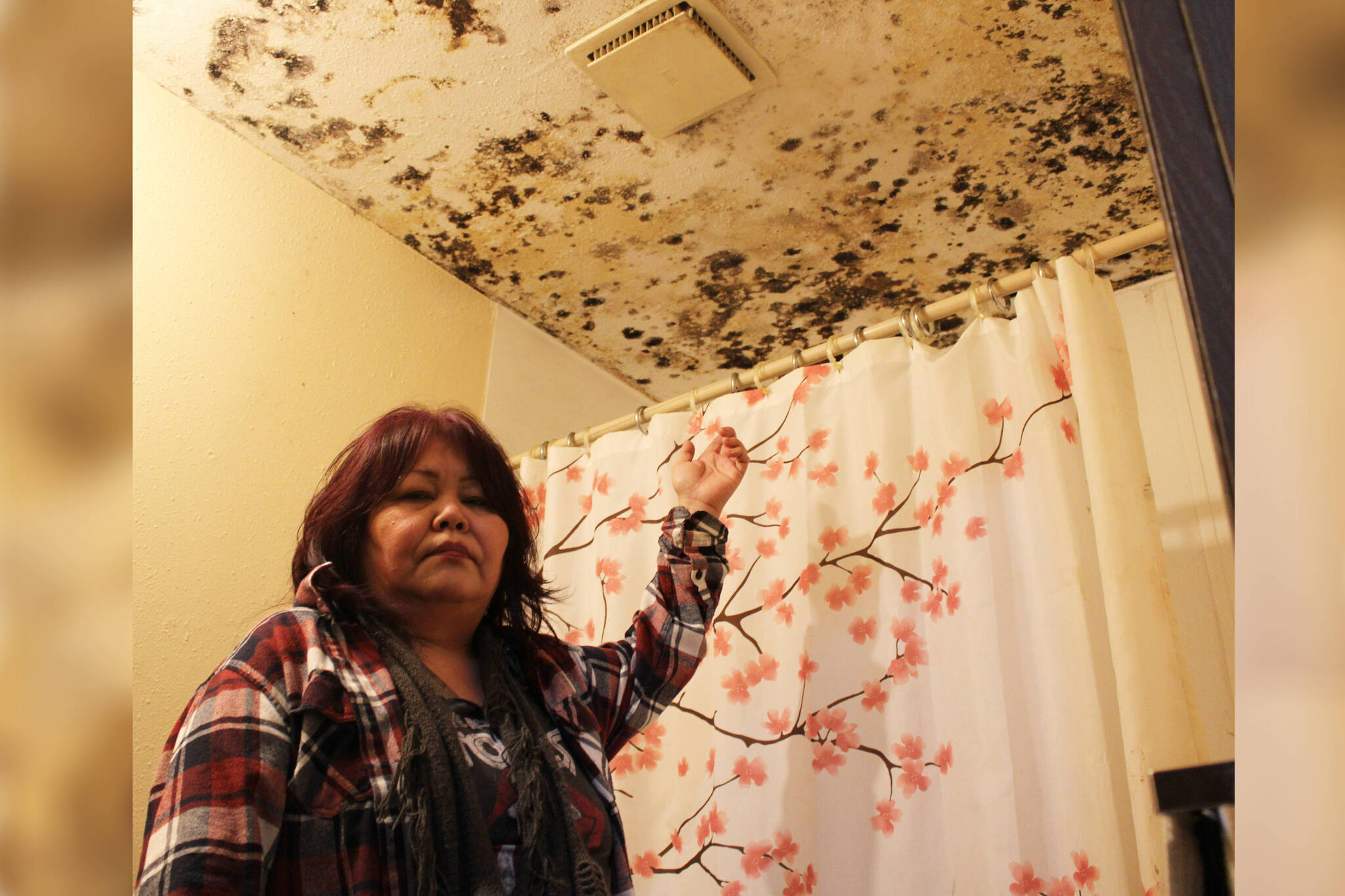 Coachman Apartments tenant Vivian Wright shows black mould covering the ceiling of her shower. (Michael Bramadat-Willcock/terrace Standard)
