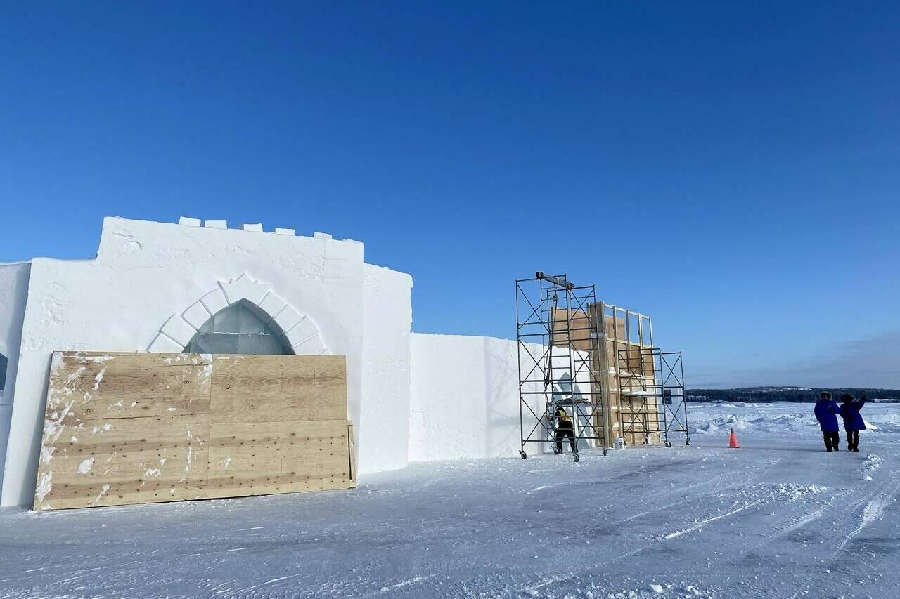 Workers construct a snow castle on Great Slave Lake’s Yellowknife Bay, in Yellowknife, Tuesday, Feb. 14, 2023. THE CANADIAN PRESS/Emily Blake