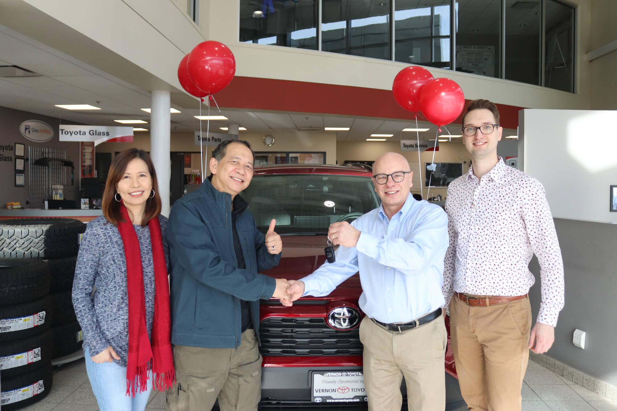 Dale Hofer of the Knights of Columbus hands the keys to a new Toyota Rav4 to Reno and Kathy Ouano, who won the vehicle as the top prize in the Knights’ 2022 charity appeal draw. (Brendan Shykora - Morning Star)