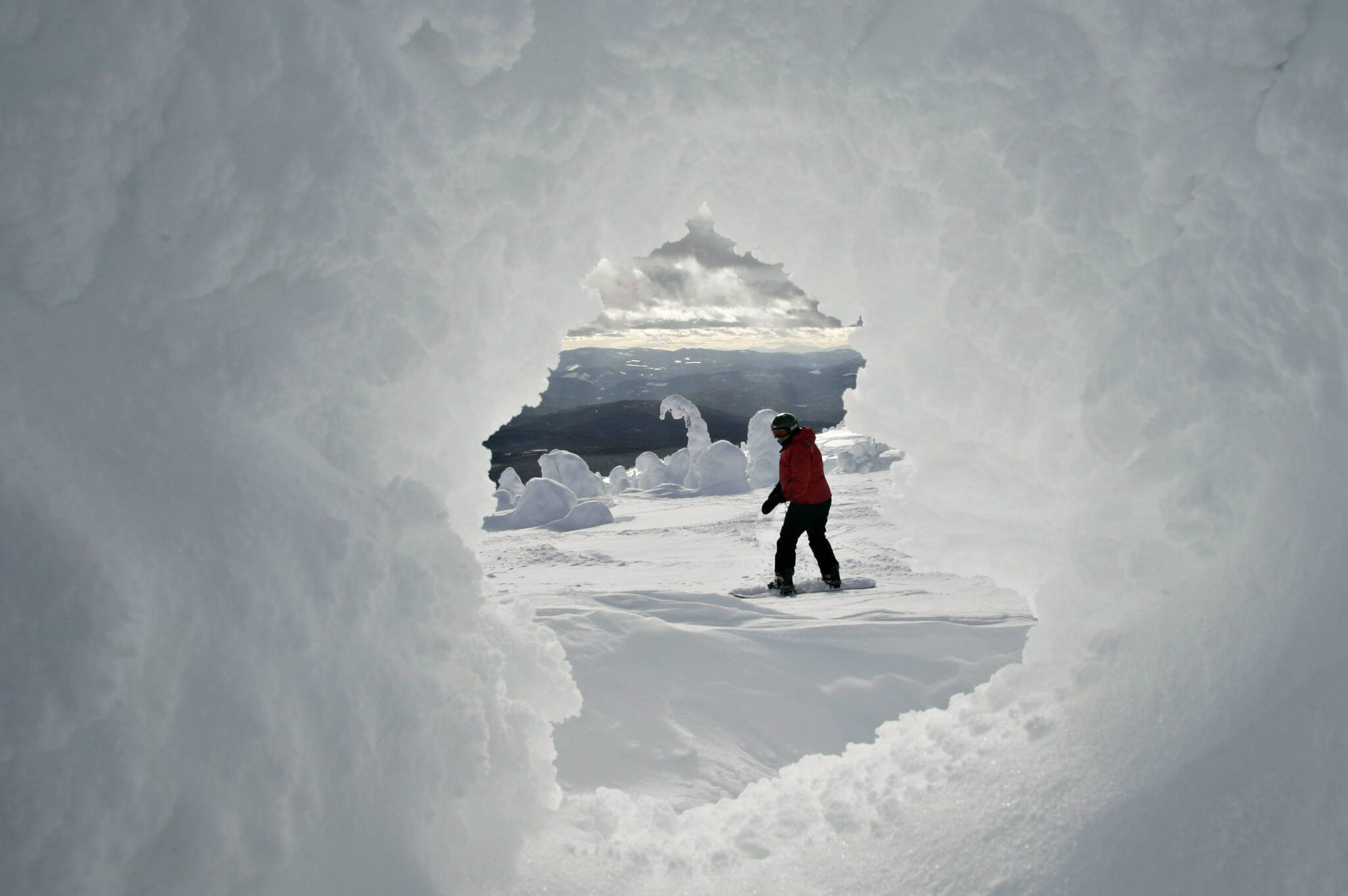 A snowboarder is seen through a so-called snow Ghots at the top of Big White ski resort Thursday, Feb. 2, 2006 near Kelowna, B.C. THE CANADIAN PRESS/Jacques Boissinot