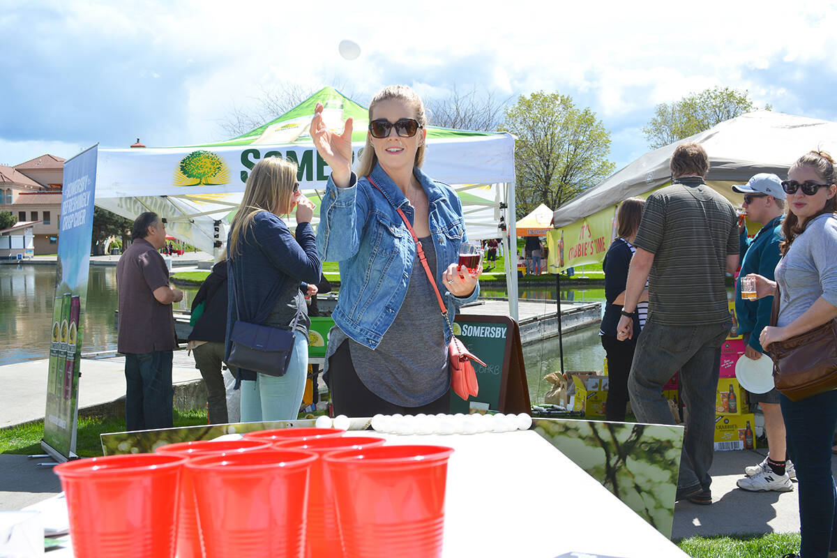 Natalie Stewart tries out her beer pong skills during the third annual Great Okanagan Beer Festival - Image Credit: Carli Berry/Capital News