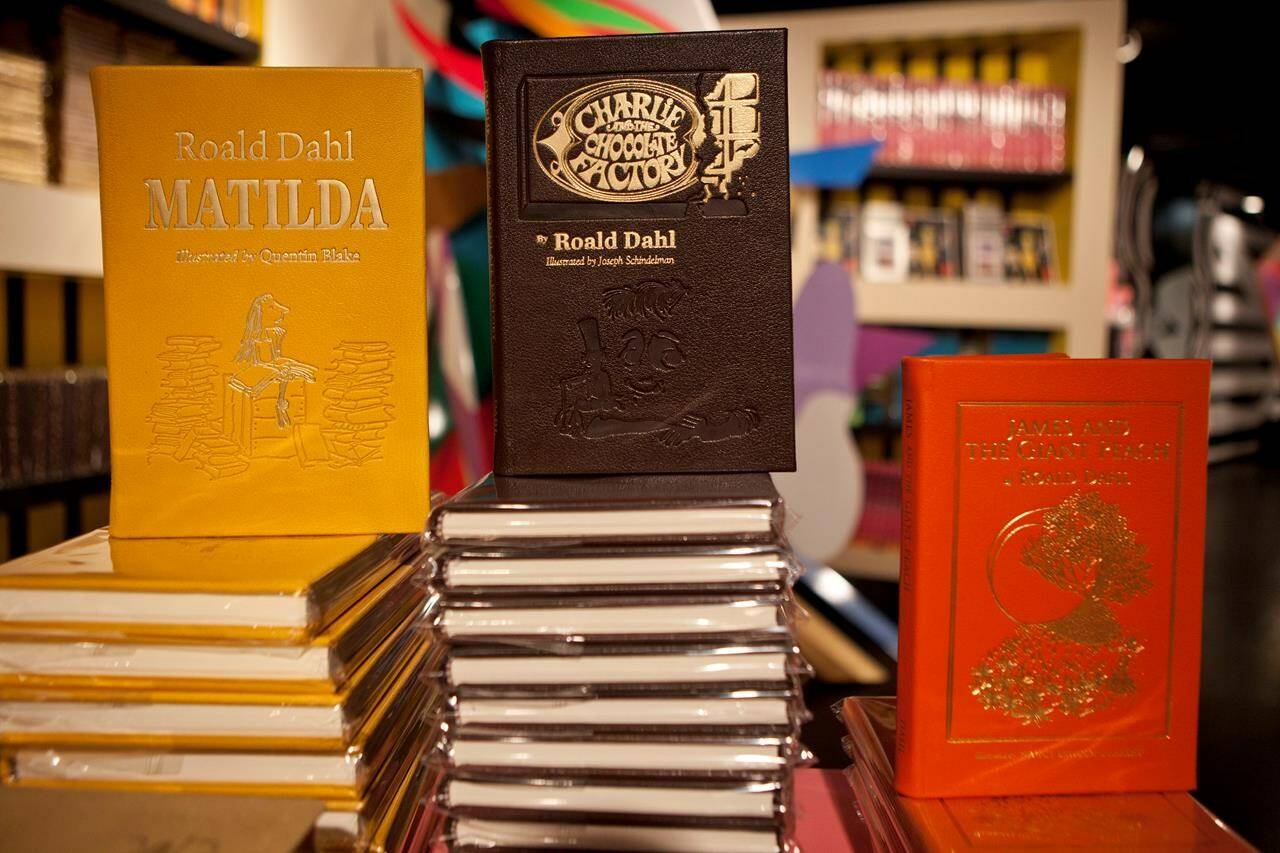 FILE - Books by Roald Dahl are displayed at the Barney’s store on East 60th Street in New York on Monday, Nov. 21, 2011. Critics are accusing the publisher of Roald Dahl’s classic children’s books of censorship after it removed colorful language from stories such as “Charlie and the Chocolate Factory” and “Matilda” to make them more acceptable to modern readers. (AP Photo/Andrew Burton, File)