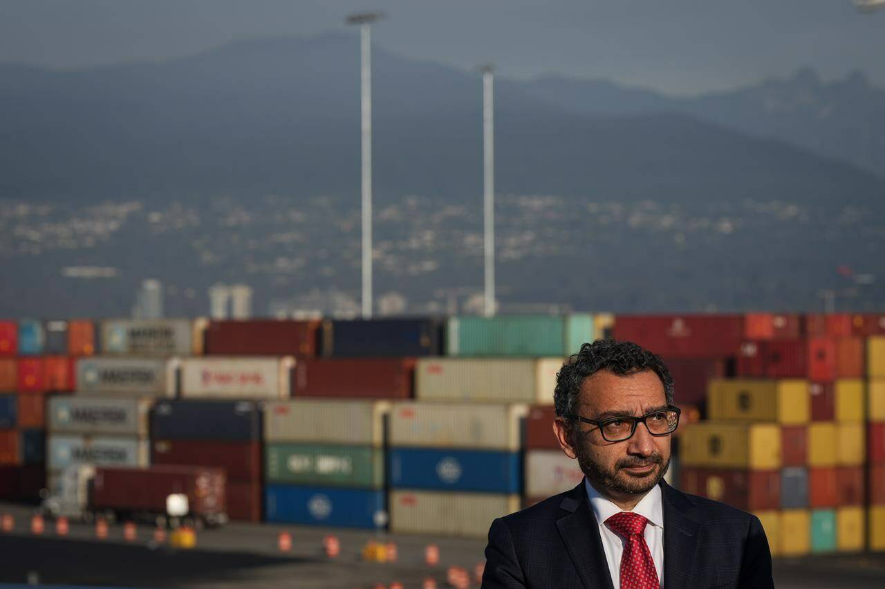 Minister of Transport Omar Alghabra listens during an announcement at Port Metro Vancouver’s Centerm container terminal, in Vancouver, B.C., Friday, Oct. 14, 2022. Four federal Liberal MPs have written to Alghabra expressing frustration with a much-criticized program that aims to replace older trucks that service the Vancouver Port Authority. THE CANADIAN PRESS/Darryl Dyck
