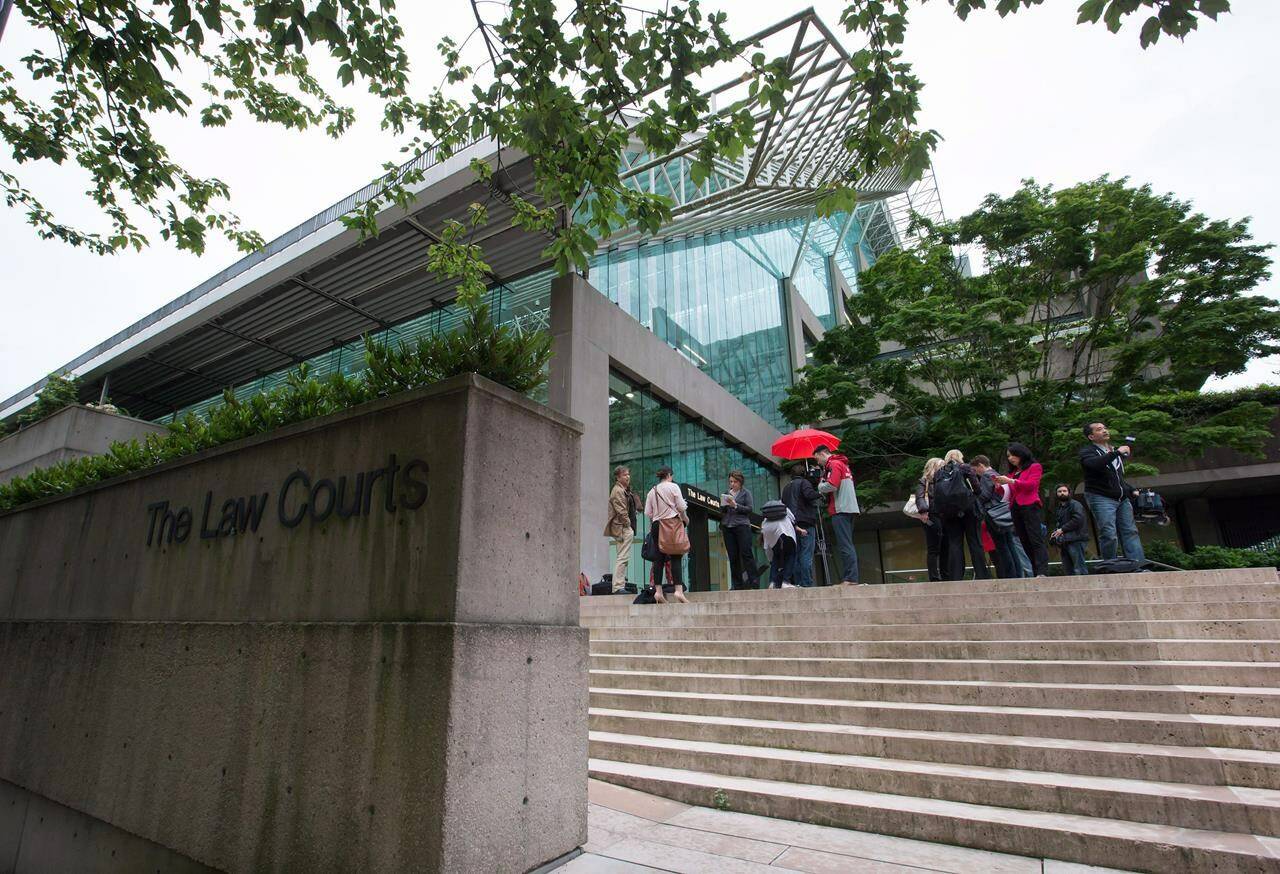 Media wait outside B.C. Supreme Court, in Vancouver, B.C., on Tuesday June 2, 2015. A proposed class-action lawsuit accuses the British Columbia government of “sexism and genocide” over a decades-long practice of coercing Indigenous women into sterilization or abortions. THE CANADIAN PRESS/Darryl Dyck