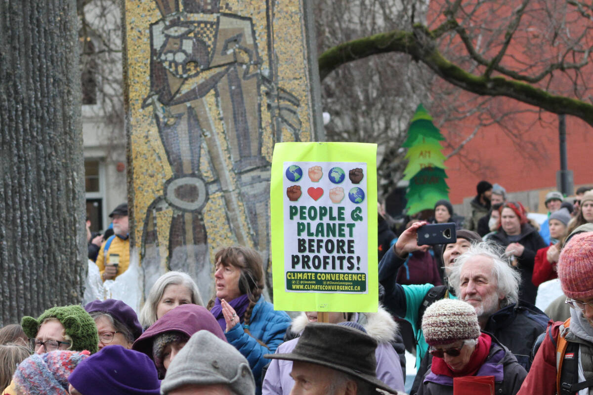 People hold signs supporting old growth protections during the march and rally Feb. 25. (Hollie Ferguson/News Staff)