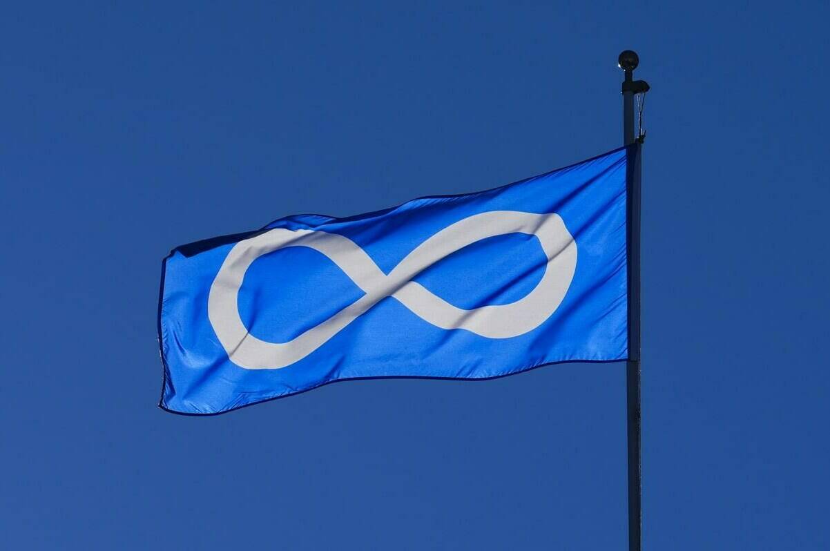 A Métis Nation flag flies in Ottawa on Tuesday, Jan. 31, 2023. Three Métis groups signed a deal Friday with the federal government that recognizes them as Indigenous governments, putting them on equal constitutional standing with First Nations and opening the door to further negotiations such as compensation for land lost. THE CANADIAN PRESS/Sean Kilpatrick