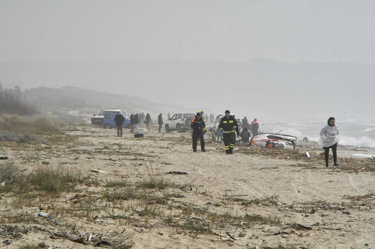 Rescuers arrive at the scene after a migrant boat broke apart in rough seas, at a beach near Cutro, southern Italy, Sunday, Feb. 26, 2023. Rescue officials say an undetermined number of migrants have died and dozens have been rescued after their boat broke apart off southern Italy. (AP Photo/Giuseppe Pipita)