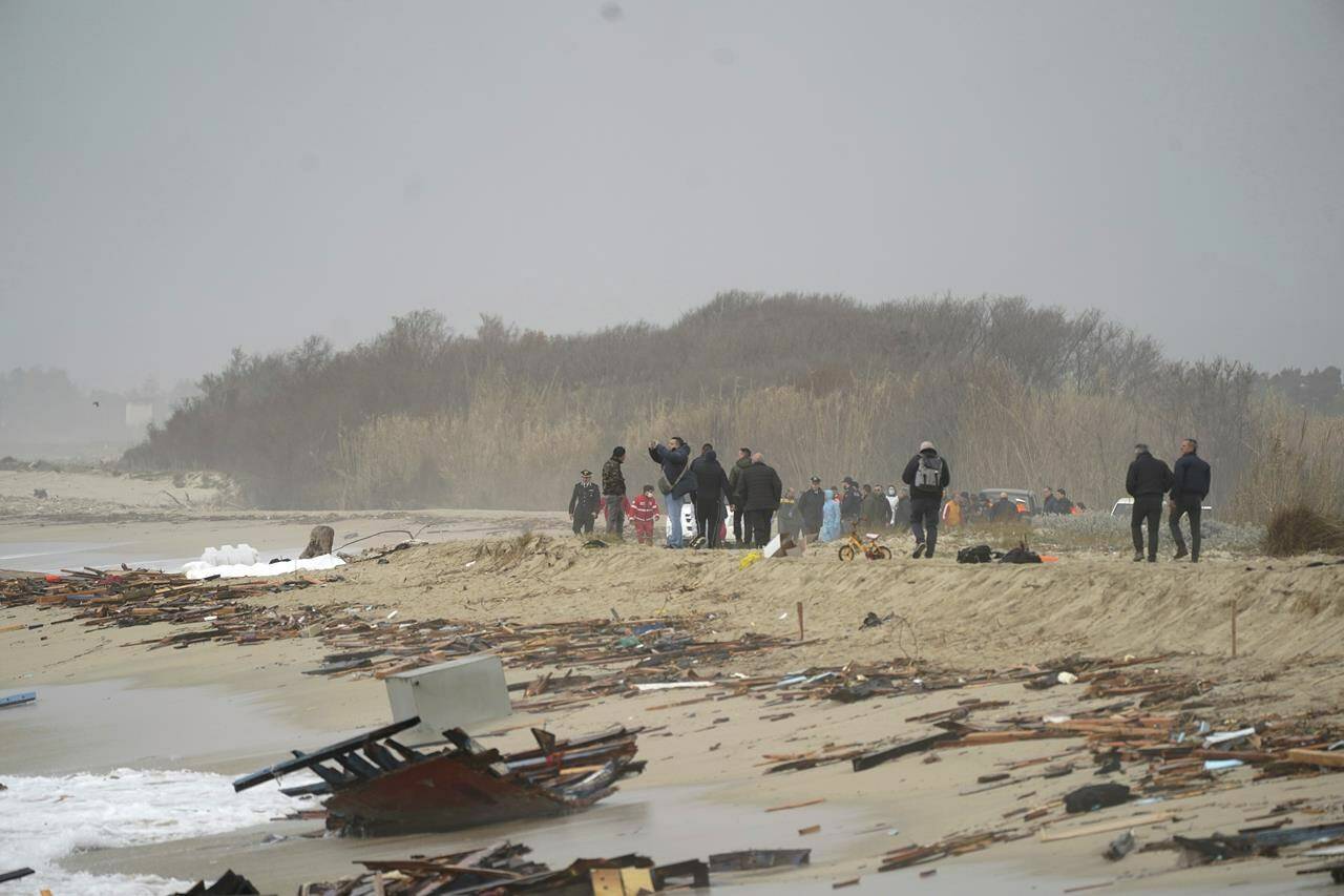The wreckage from a capsized boat washes ashore at a beach near Cutro, southern Italy, Sunday, Feb. 26, 2023. Rescue officials say an undetermined number of migrants have died and dozens have been rescued after their boat broke apart off southern Italy. (Antonino Durso/LaPresse via AP)