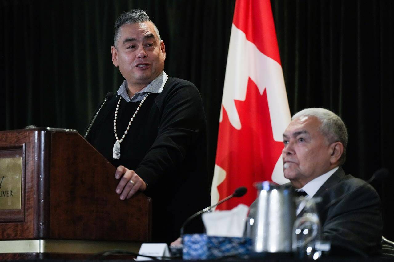 Former Tk’emlups te Secwepemc chief Shane Gottfriedson, left, speaks as hiwus (Chief) Warren Paull, of the Sechelt (shishalh) First Nation, listens during a news conference, in Vancouver, B.C., Saturday, Jan. 21, 2023. Scores of First Nations leaders are voicing their formal support in court for a $2.8-billion settlement agreement to a class-action residential schools lawsuit. THE CANADIAN PRESS/Darryl Dyck
