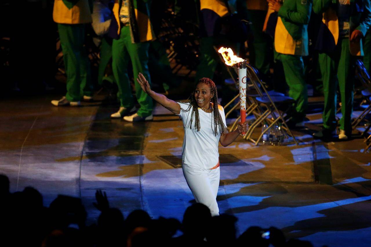Charmaine Crooks carries the Pan Am flame during the opening ceremony of the 2015 Pan Am Games in Toronto, Friday, July 10, 2015. Canada Soccer named five-time Olympian Crooks as its interim president on Wednesday, as the embattled national sports organization looks to broker labour peace with its men’s and women’s teams.THE CANADIAN PRESS/AP/Julio Cortez