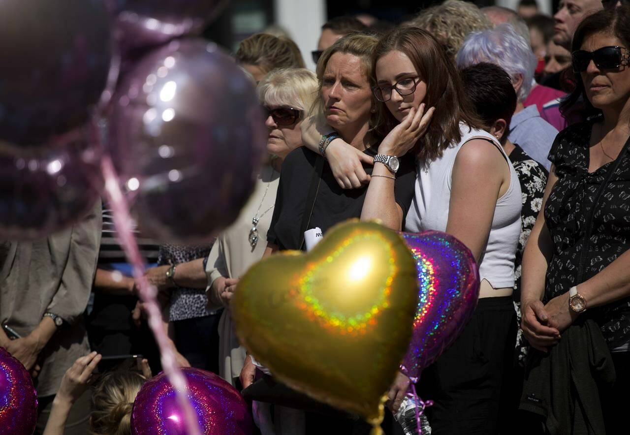 FILE - People hold a minute of silence in a square in central Manchester, England, on May 25, 2017, after a suicide bombing attack at an Ariana Grande concert at the Manchester Arena. Britain’s domestic intelligence agency didn’t act swiftly enough on key information and missed a significant opportunity to prevent the suicide bombing that killed 22 people at a 2017 Ariana Grande concert, an inquiry found Thursday, March 2, 2023. (AP Photo/Emilio Morenatti, File)
