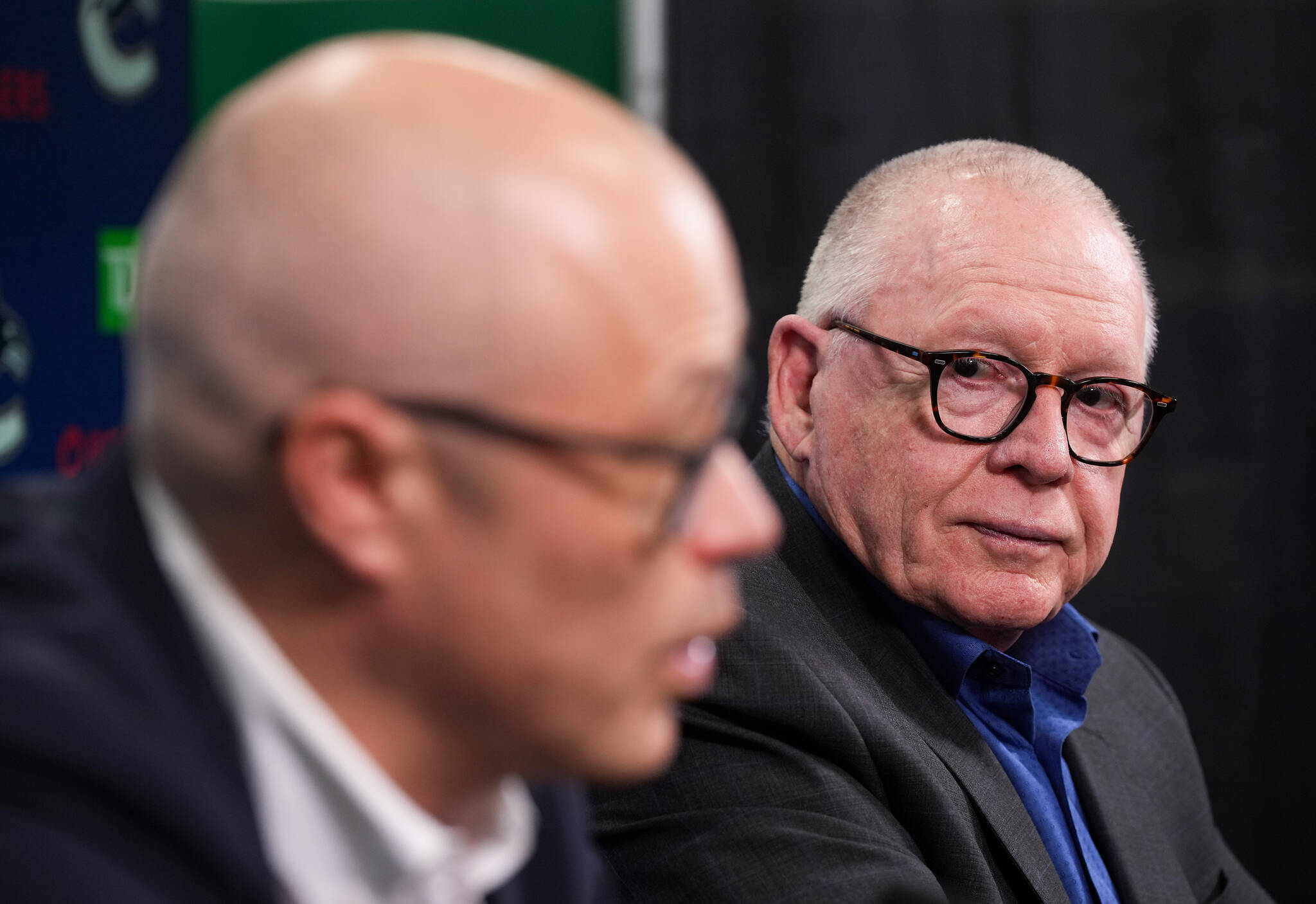 Vancouver Canucks president of hockey operations Jim Rutherford, back right, listens as general manager Patrik Allvin responds to a question during an end of NHL hockey season news conference, in Vancouver, on Tuesday, May 3, 2022. THE CANADIAN PRESS/Darryl Dyck