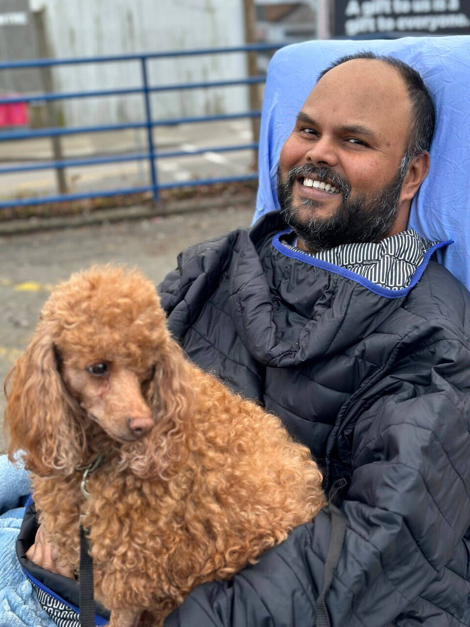 Kris Mallisetty, seen here with poodle Erica, was paralyzed from the neck down during surgery on his spine on Jan. 27. Because he doesn’t qualify for Persons With Disability funding, a friend has set up a fundraiser to help pay for the costs of making his home wheelchair-accessible. (Leah Gray photo)