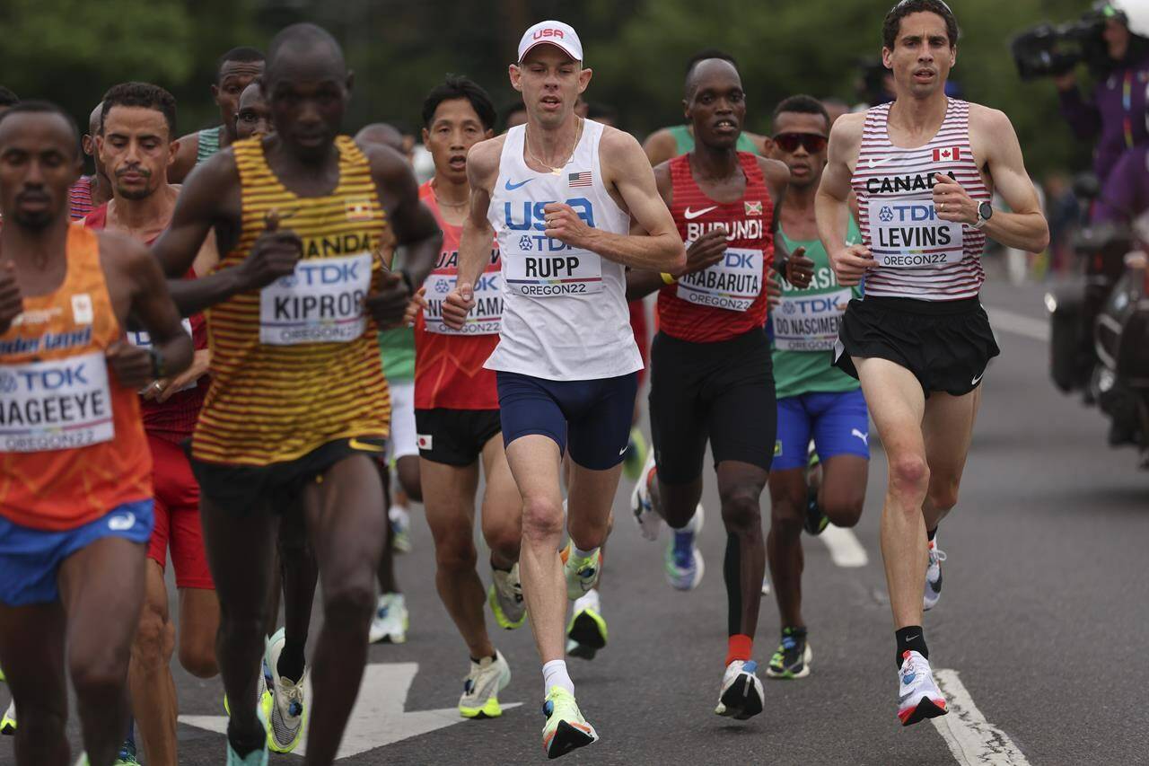Galen Rupp, of the United States, and Cam Levins of Canada (right) compete during the men’s marathon at the World Athletics Championships in Eugene, Ore., Sunday, July 17, 2022. Levins broke both the national and North American records at the Tokyo Marathon on Saturday. THE CANADIAN PRESS/AP-Patrick Smith/Pool Photo via AP