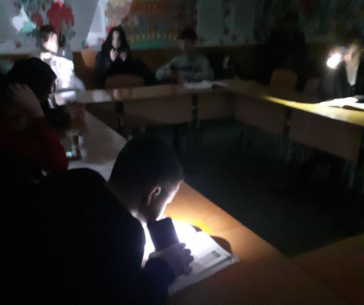 Students in Kovalivka, Ukraine study by phone light in dark bomb shelters. (Valery Shulga/Submitted)
