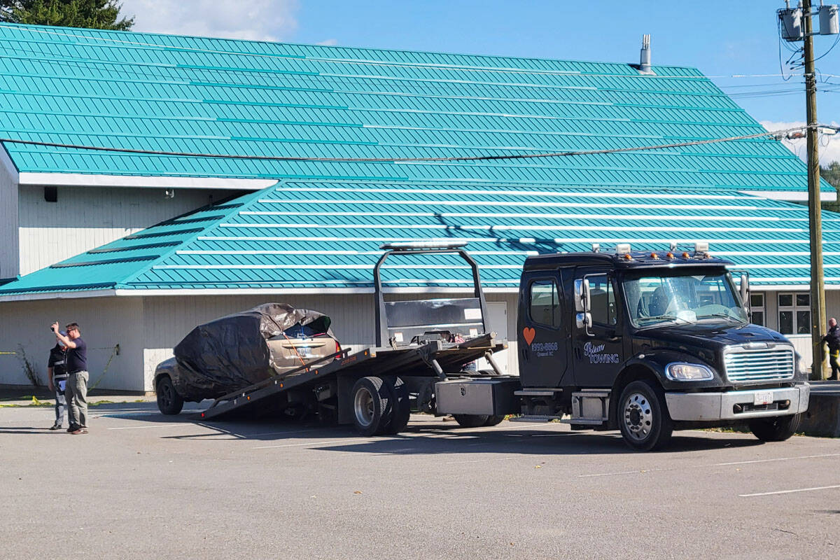 A tow truck loads a SUV in the parking lot of the Quesnel Seniors’ Centre in 2021. Police say they approached the vehicle to check on a sleeping man, who produced a gun, and was shot by officers. (Cassidy Dankochik file photo - Quesnel Cariboo Observer)