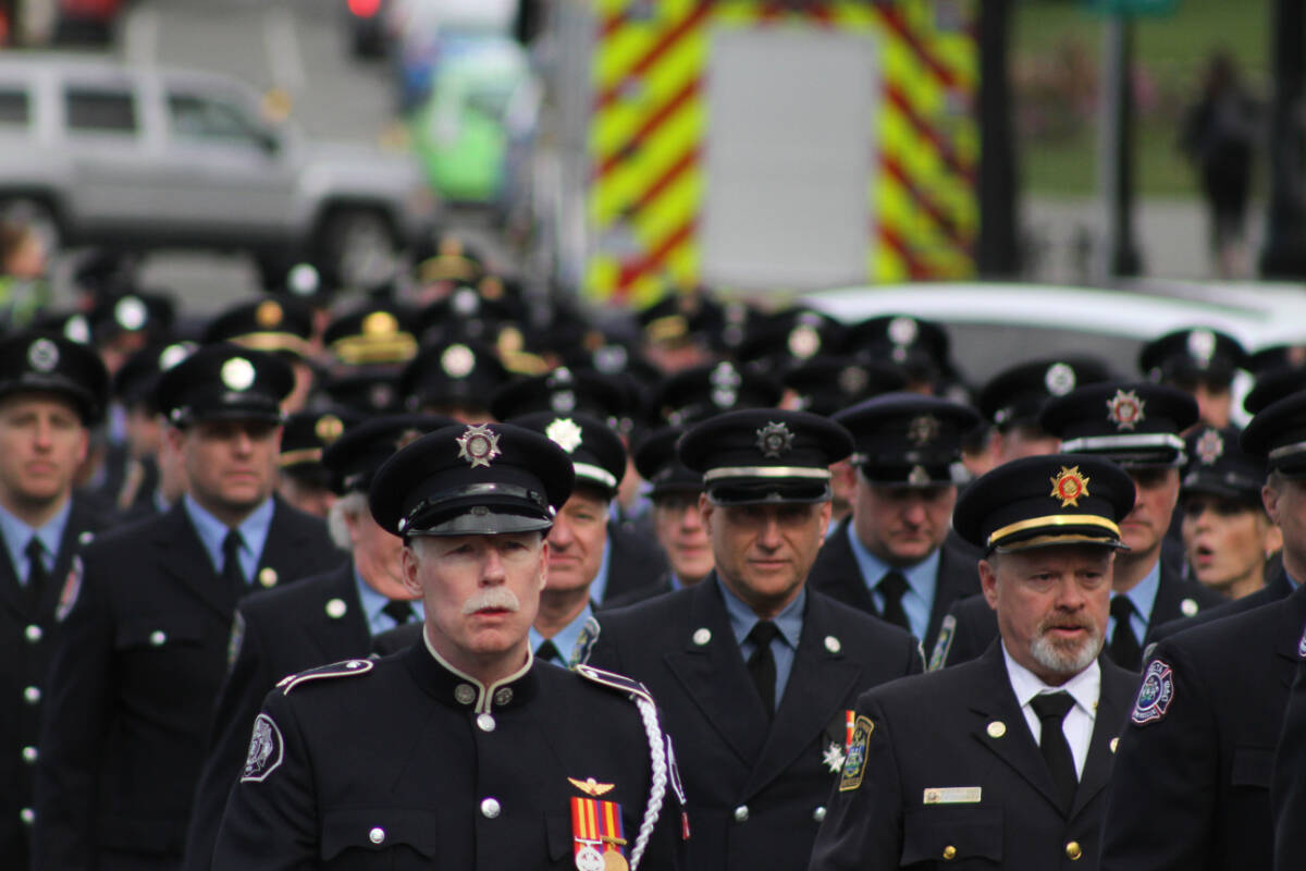 Firefighters from all across the province march along Menzies Street to the south lawn of the legislature in Victoria to honour those who died in the line of duty Monday (March 6). (Austin Westphal/News Staff)