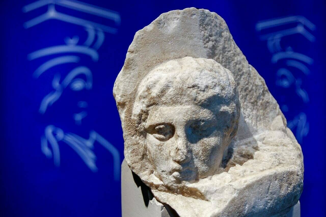 FILE - The marble head of a young man, a tiny fragment from the 2,500-year-old sculptured decoration of the Parthenon Temple on the ancient Acropolis, is displayed during a presentation to the press at the new Acropolis Museum in Athens, Nov. 5, 2008. The Vatican and Greece were finalizing a deal Tuesday March 7, 2023 to return three fragments of the Parthenon Marbles that have been in the collection of the Vatican Museums for two centuries. (AP Photo/Thanassis Stavrakis, File)