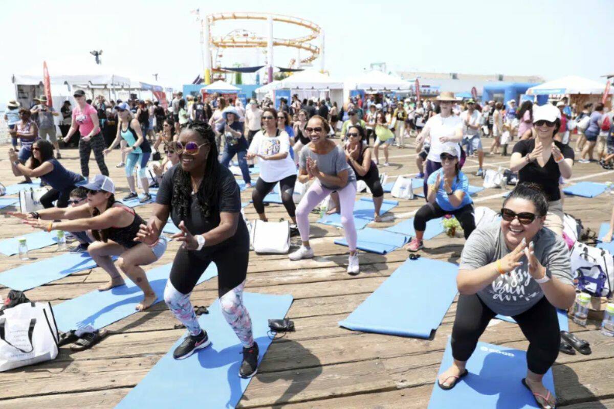 IMAGE DISTRIBUTED FOR WEIGHT WATCHERS - At a WW GOOD wellness festival powered by Weight Watchers "WW" on the Santa Monica Pier on August 11, 2018, Los Angeles residents engage in a movement and meditation series ("LIFTED") led by Celebrity Fitness Instructor Holly Rilinger. WW International, better known as WeightWatchers, is buying telehealth platform Sequence, giving its members access to a program that offers prescriptions to obesity medications. Shares of WW International Inc. jumped nearly 12% before the market open on Tuesday, March 7, 2023. (Matt Sayles/AP Images for Weight Watchers)