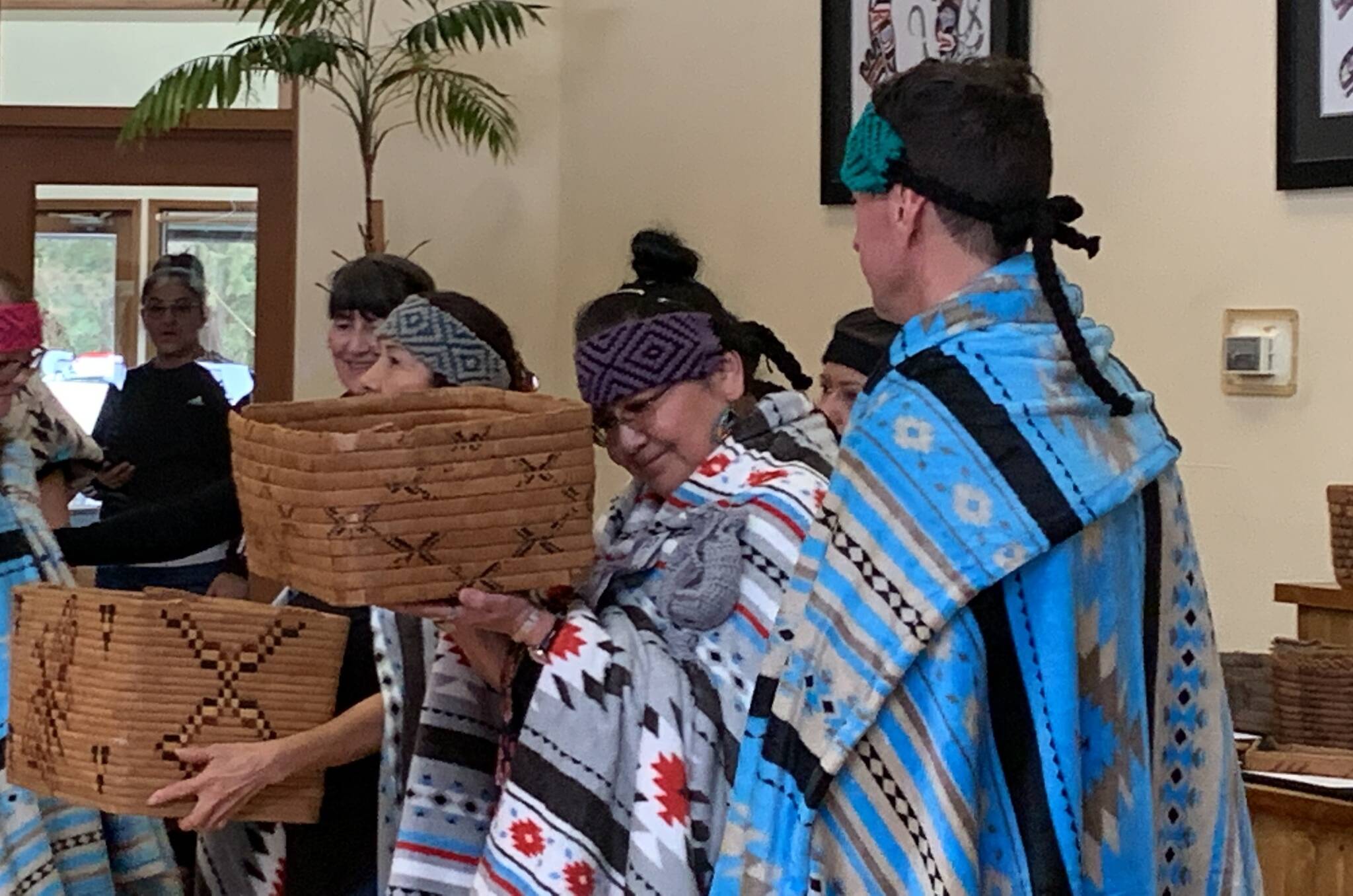 Claudette Leon reacts as she holds a repatriated Sts’ailes basket during a ceremony on Friday, March 3. A total of 29 baskets were returned to the Sts’ailes First Nation. (Adam Louis/Observer)