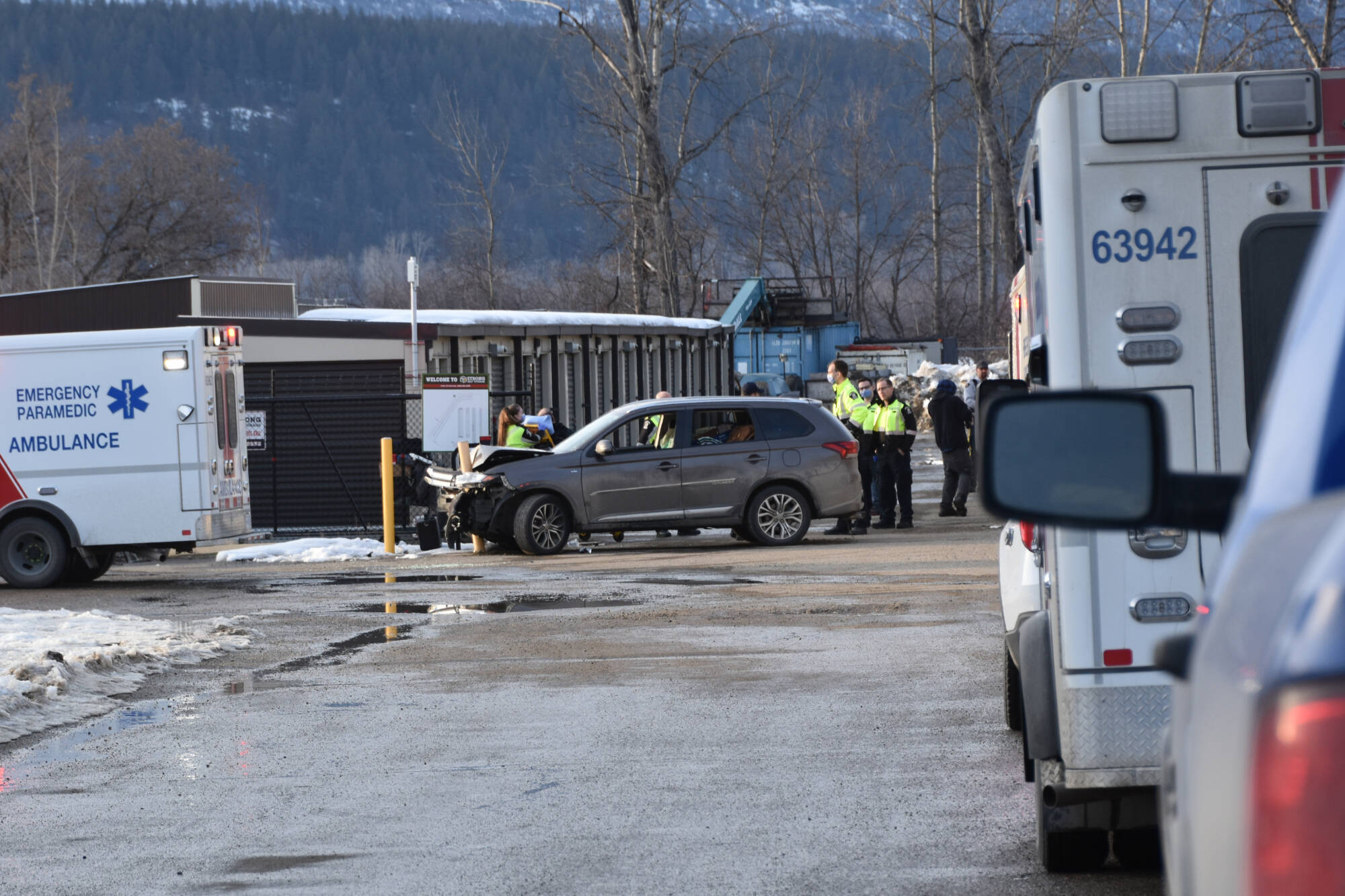 Several police vehicles and ambulances were converged on the roadway next to the Starbucks drive-thru in Salmon Arm about 4:45 p.m. on Monday, March 6 where a vehicle had crashed into a concrete post. The yellow post can be seen embedded in the hood of the vehicle. (Martha Wickett-Salmon Arm Observer)