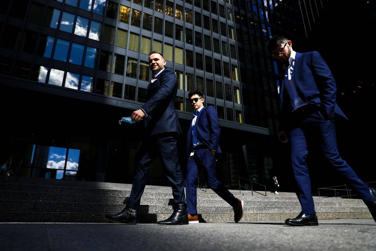 A group of men walk in the financial district in Toronto on Wednesday, September 29, 2021. A new survey suggests Canadian men are almost twice as likely as women to think gender inequality is being “blown way out of proportion.” THE CANADIAN PRESS/Evan Buhler