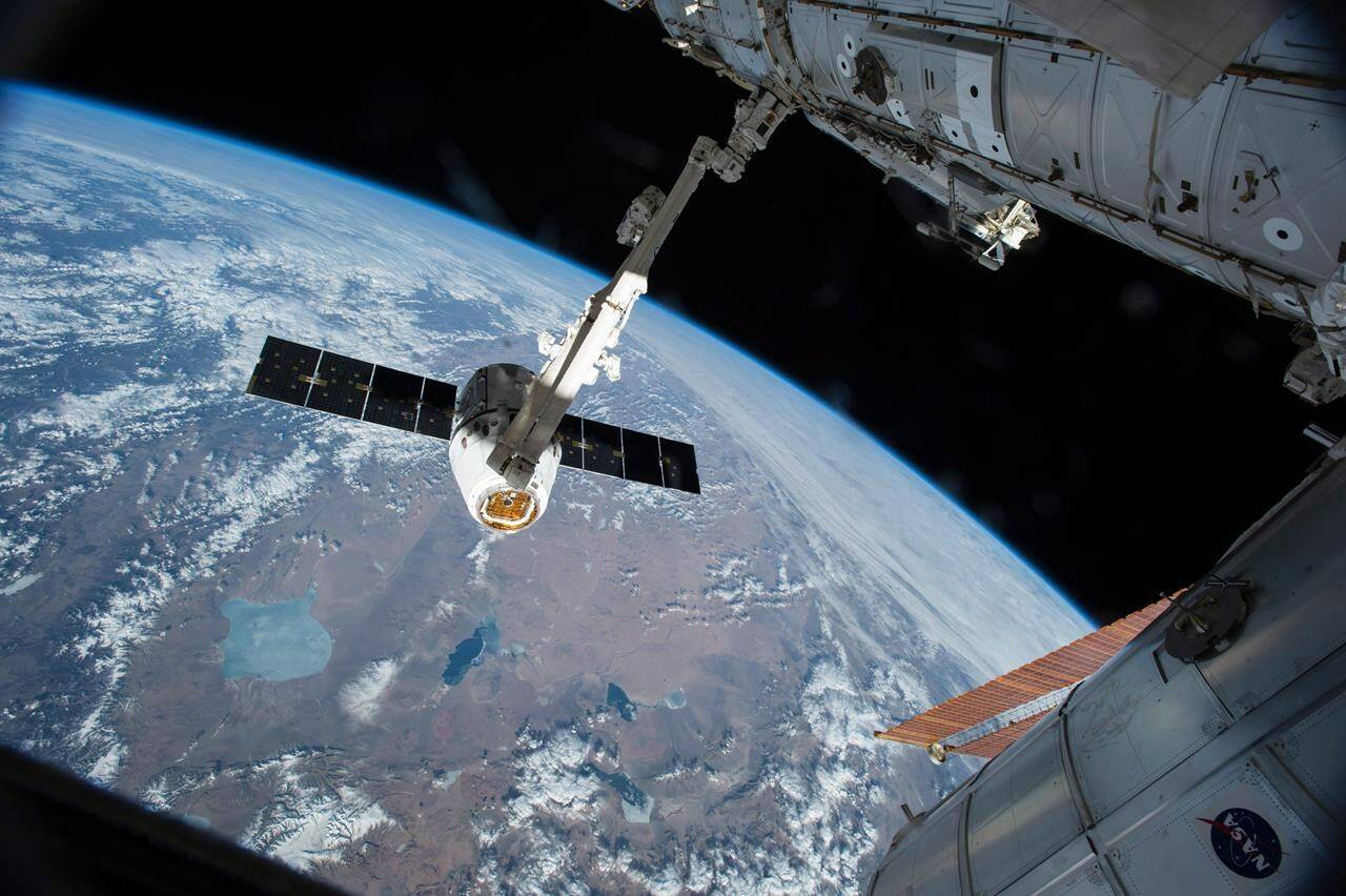 The Canadarm 2 reaches out to capture the SpaceX Dragon cargo spacecraft and prepare it to be pulled into its port on the International Space Station. Who was the first Canadian female astronaut? ( THE CANADIAN PRESS/AP-HO, NASA)