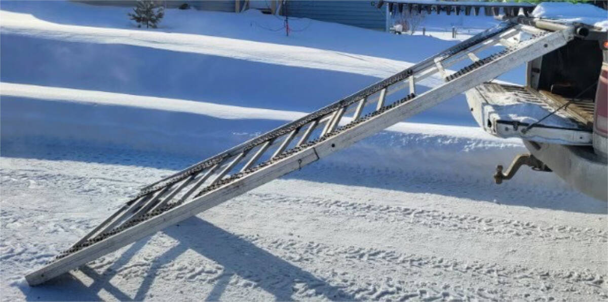 A snowmobile ramp hooked on a sled deck but lacking safety tabs, called “dogs” which prevent it from flipping off, has been cited as the issue behind a crash and deadly head injury for Trevor Pierce as he was loading his snowmobile in February. (Photo submitted)
