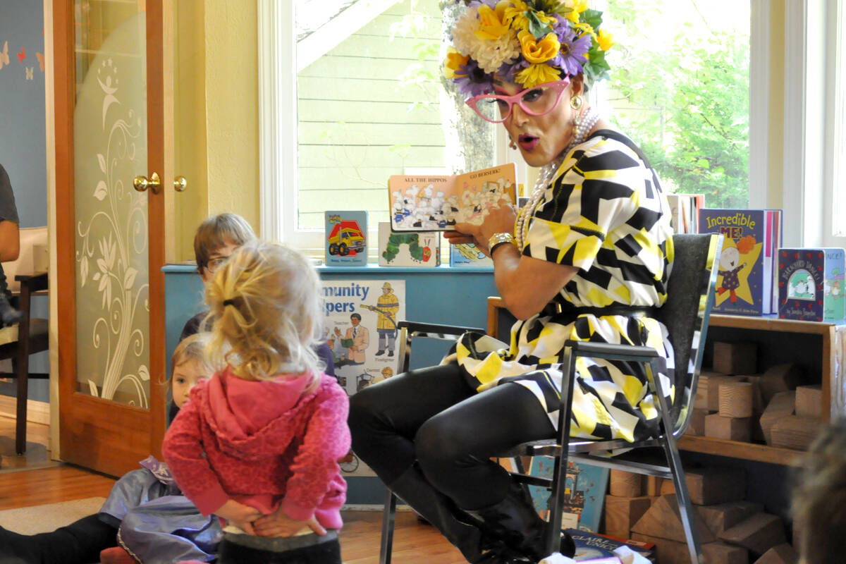 Nelson’s Chase Adams reads to a child during a drag story time at Kootenay Kids in 2018. A similar event has been postponed by the Nelson Public Library due to online backlash. Photo: Tyler Harper