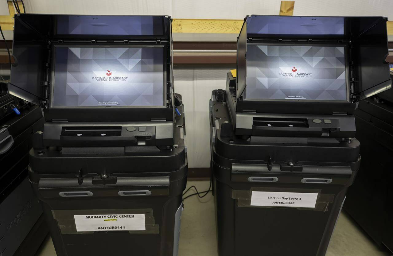 FILE - Dominion Voting ballot-counting machines are shown at a Torrance County warehouse during election equipment testing with local candidates and partisan officers in Estancia, N.M., Sept. 29, 2022. Dominion Voting Systems is suing Fox for $1.6 billion, claiming the news outlet repeatedly aired allegations that the company engaged in fraud that doomed President Donald Trump’s re-election campaign while knowing they were untrue. Fox contends that it was reporting newsworthy charges made by supporters of the president and is supported legally by libel standards. The case is scheduled for trial next month. (AP Photo/Andres Leighton, File)