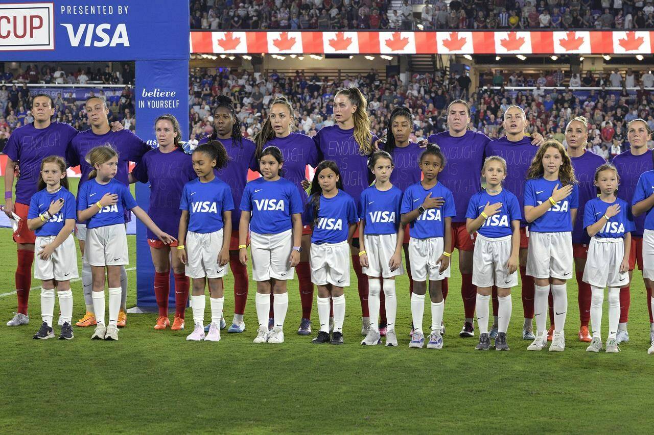 Canada players wear purple shirts with “Enough is Enough” written on them during the Canadian national anthem before the team’s SheBelieves Cup women’s soccer match against the United States, Thursday, Feb. 16, 2023, in Orlando, Fla. Members of the Canadian women’s soccer team take their fight for pay equity to Parliament today. THE CANADIAN PRESS/AP, Phelan M. Ebenhack