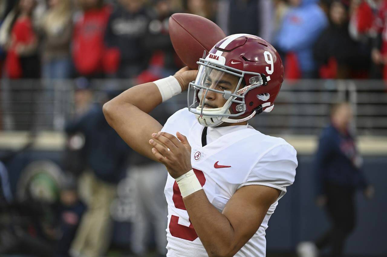 FILE - Alabama quarterback Bryce Young (9) warms up on the sidelines during the first half of an NCAA college football game against Mississippi in Oxford, Miss., Saturday, Nov. 12, 2022. The Panthers have traded up to acquire the No. 1 overall pick in the draft from the Chicago Bears in exchange for Carolina's No. 9 and No. 61 overall picks in 2023, a first-round pick in 2024, a second-round pick in 2025 and star wide receiver D.J. Moore, two people familiar with the deal said Friday, March 10, 2023, The people spoke to The Associated Press on condition of anonymity because the trade had not been announced. The move allows the Panthers to acquire a potential franchise quarterback, although it remains unclear which player the team prefers. (AP Photo/Thomas Graning, File)