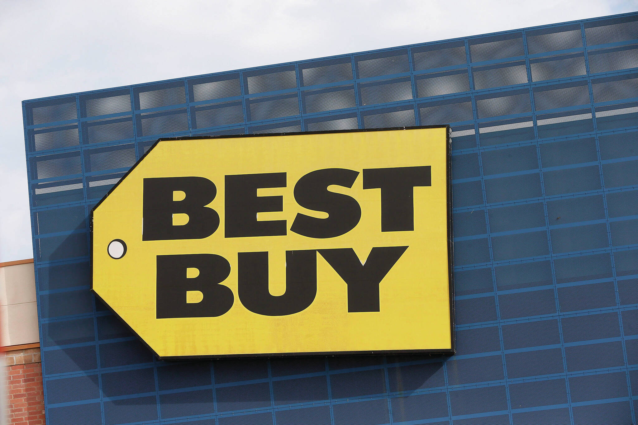In this Aug. 27, 2019 photo, the Best Buy logo is shown on a store in Richfield, Minn. Best Buy announced plans to lay off about 700 employees in Canada in January. (AP Photo/Jim Mone)