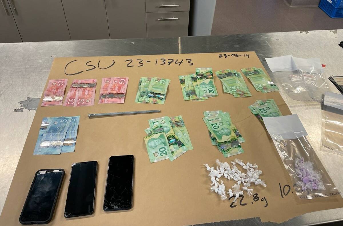 Drugs, phones, weapons and cash seized by Kelowna RCMP on March 14. (RCMP/Submitted)