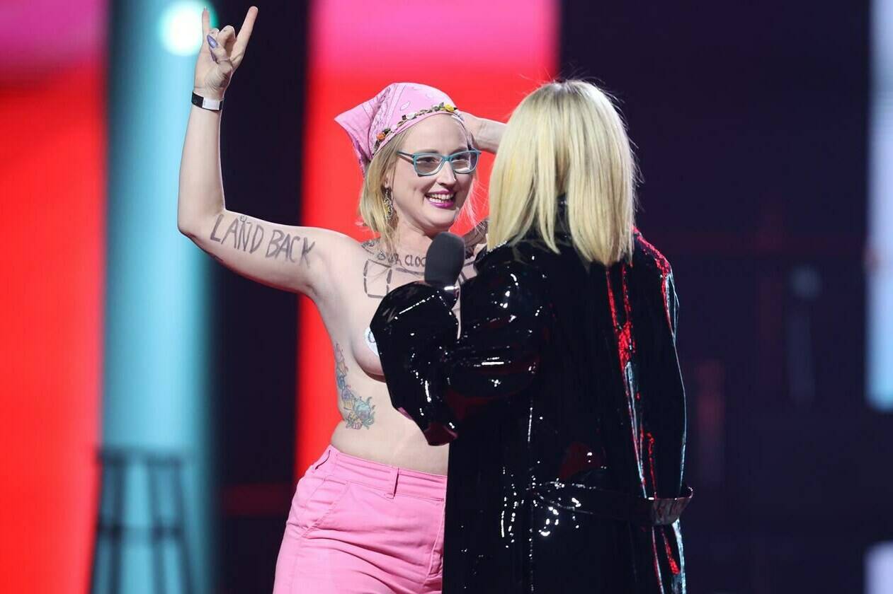 Avril Lavigne confronts a topless protester during the Junos on Monday, March 13, 2023. Casey Hatherly, 37, has appeared in Edmonton court on a charge of mischief.THE CANADIAN PRESS/Timothy Matwey