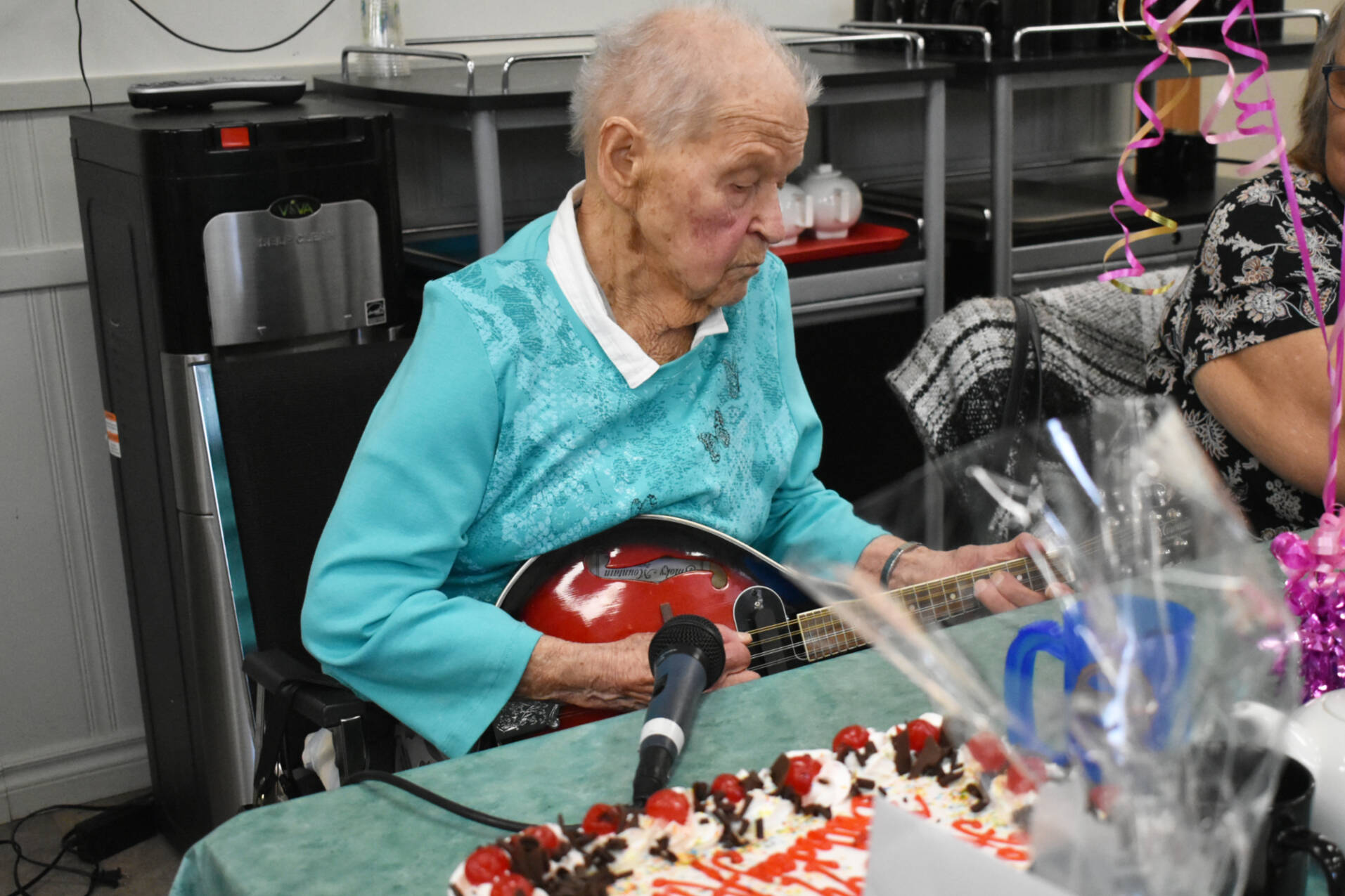 Alli Graham plays the mandolin at her 99th birthday party at the Sicamous and District Seniors Centre Society Wednesday, March 15, 2023. (Rebecca Willson/ Eagle Valley News)
