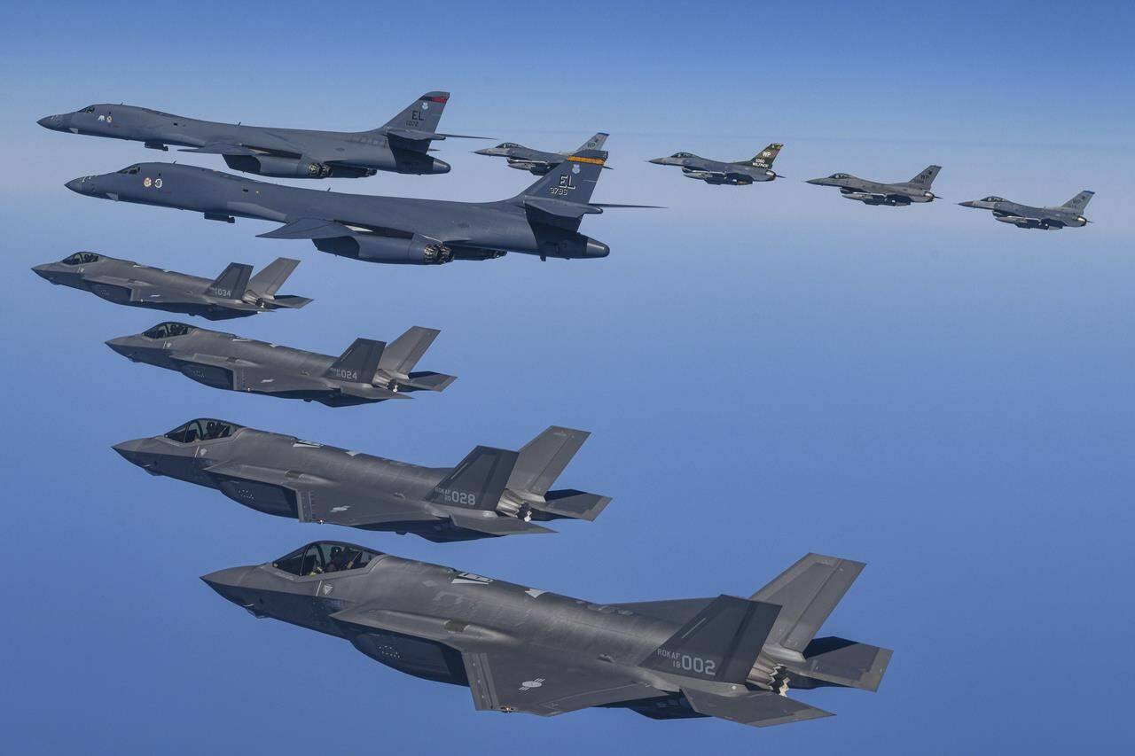 In this photo provided by South Korea Defense Ministry, U.S. Air Force B-1B bombers, top center, fly in formation with South Korea’s Air Force F-35A fighter jets and U.S. Air Force F-16 fighter jets, top right, over the South Korea Peninsula during a joint air drill in South Korea, Sunday, March 19, 2023. North Korea launched a short-range ballistic missile toward the sea on Sunday, its neighbors said, ramping up testing activities in response to U.S.-South Korean military drills that it views as an invasion rehearsal. (South Korea Defense Ministry via AP)