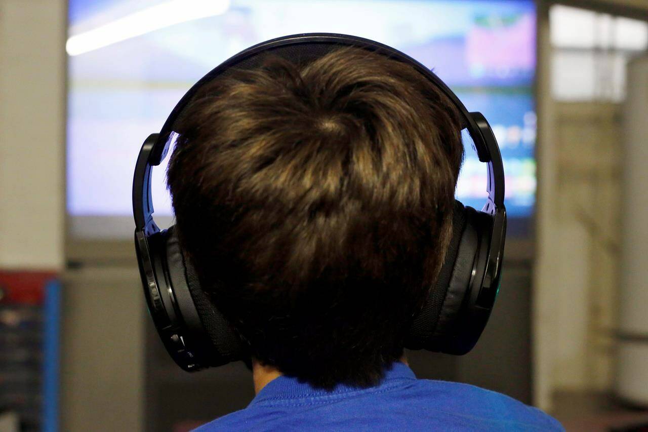 A child plays the video game “Fortnite” in Chicago, Saturday, Oct.6, 2018. A Vancouver parent has launched a proposed class-action lawsuit against the makers of Fortnite, saying the popular video game is designed to be “as addictive as possible” for children. THE CANADIAN PRESS/AP/Martha Irvine