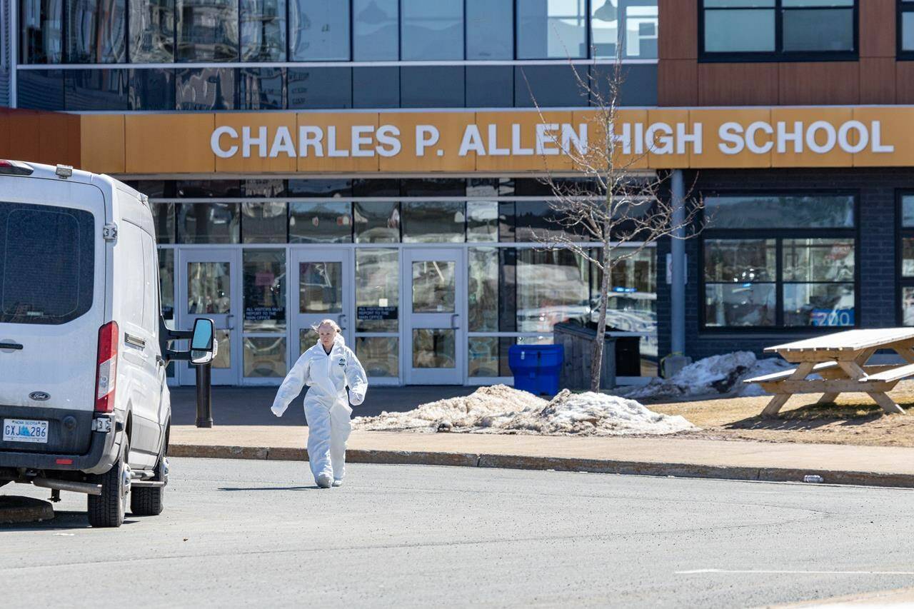 Forensics on the scene at Charles P. Allen High School in Halifax, Monday, March 20, 2023. Halifax police have arrested a student after three people were stabbed at a high school this morning. THE CANADIAN PRESS/Riley Smith