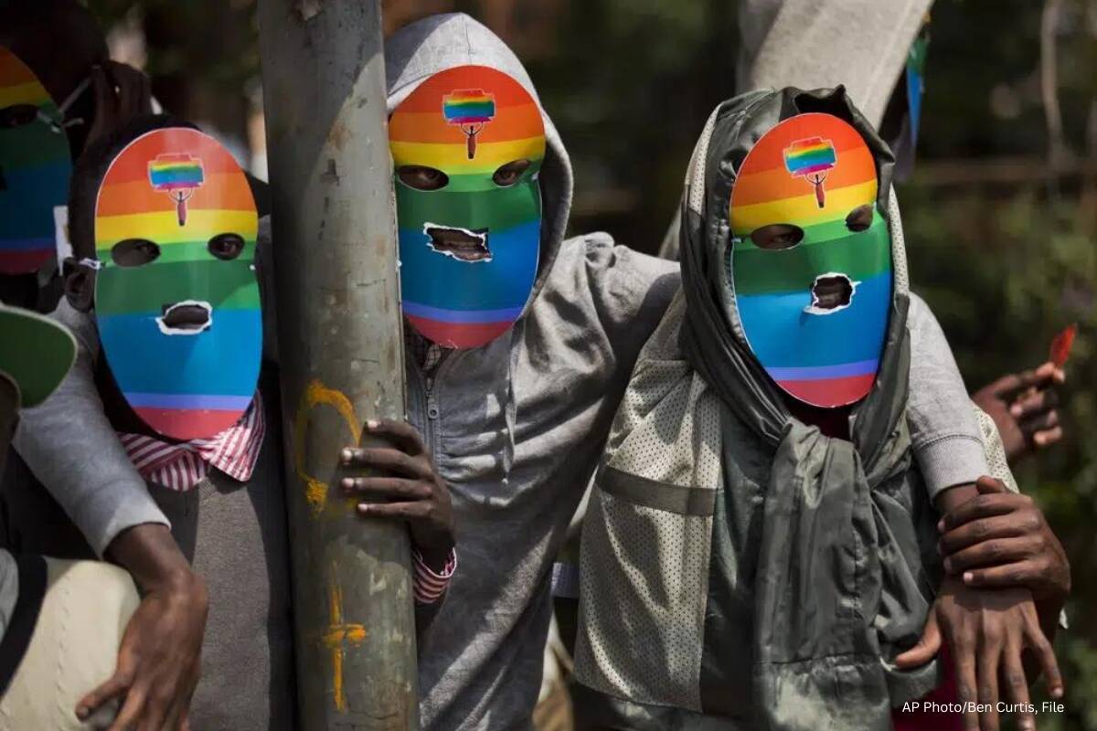 Kenyan gays and lesbians and others supporting their cause wear masks to preserve their anonymity as they stage a rare protest against Uganda's tough stance against homosexuality and in solidarity with their counterparts there, outside the Uganda High Commission in Nairobi, Kenya on Feb. 10, 2014. Ugandan lawmakers passed a bill Tuesday, March 21, 2023 prescribing jail terms of up to 10 years for offenses related to same-sex relations, responding to popular sentiment but piling more pressure on the East African country's LGBTQ community. (AP Photo/Ben Curtis, File)