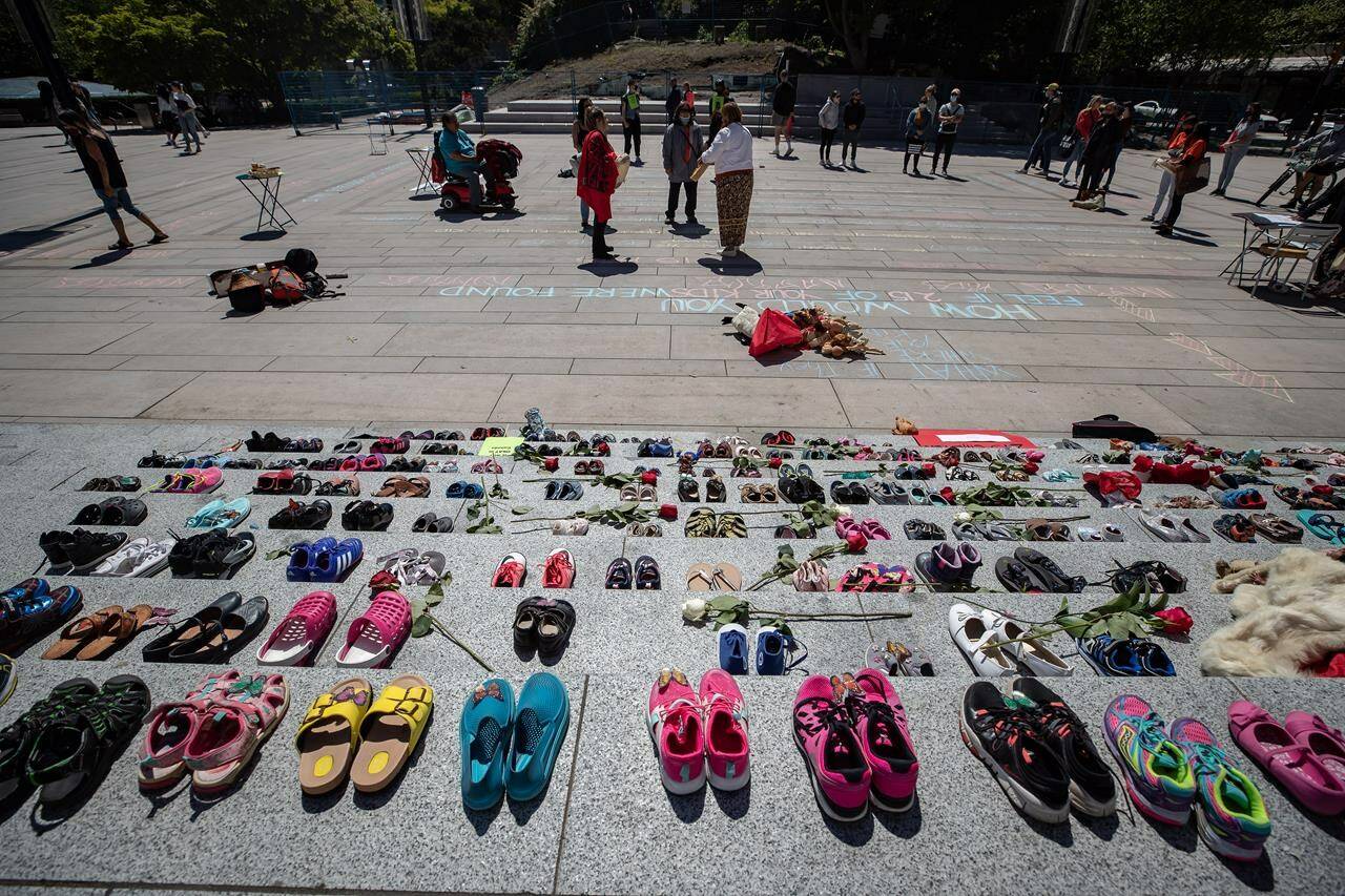 Two hundred and fifteen pairs of children’s shoes are placed on the steps of the Vancouver Art Gallery n Vancouver on Friday, May 28, 2021, as a memorial to children who did not return from residential schools. THE CANADIAN PRESS/Darryl Dyck