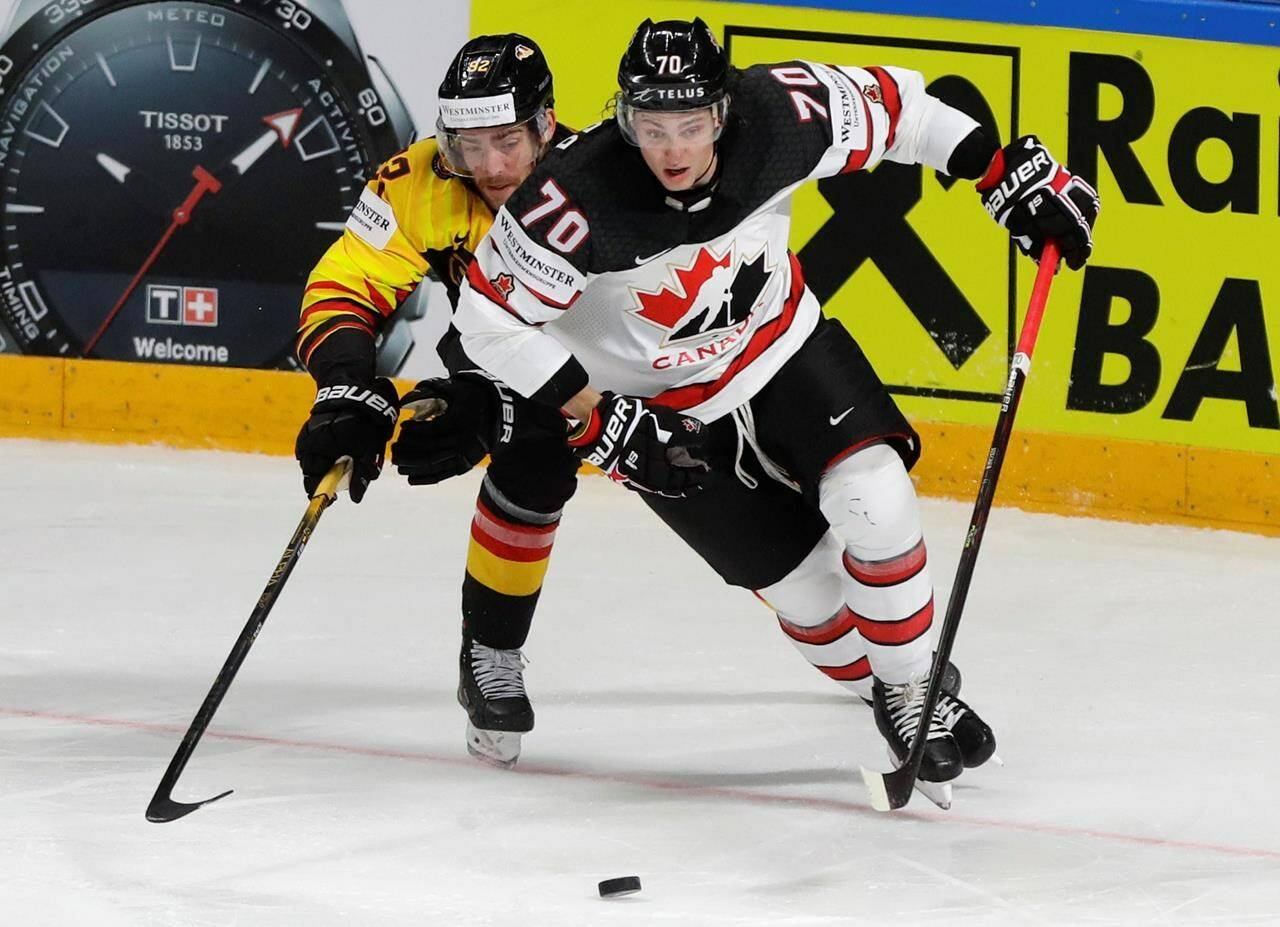 Germany’s Marcel Noebels, left, challenges for the puck with Canada’s Troy Stecher during the Ice Hockey World Championship group B match between Germany and Canada at the Arena in Riga, Latvia, Monday, May 24, 2021. THE CANADIAN PRESS/AP, Sergei Grits