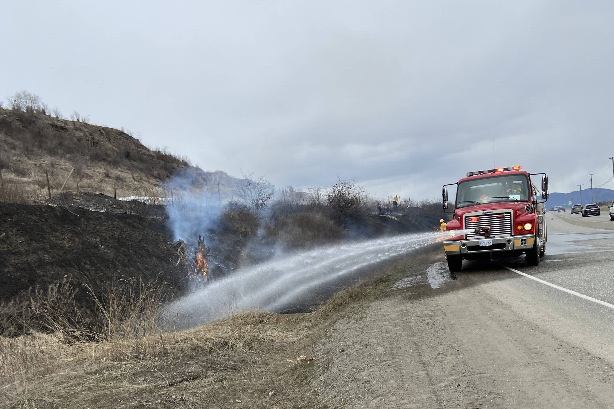 The Armstrong Spallumcheen Fire Department extinguished a 300-foot grass fire just north of the intersection of Old Kamloops Road and Highway 97 Friday, March 31, 2023. (David Evans photo)